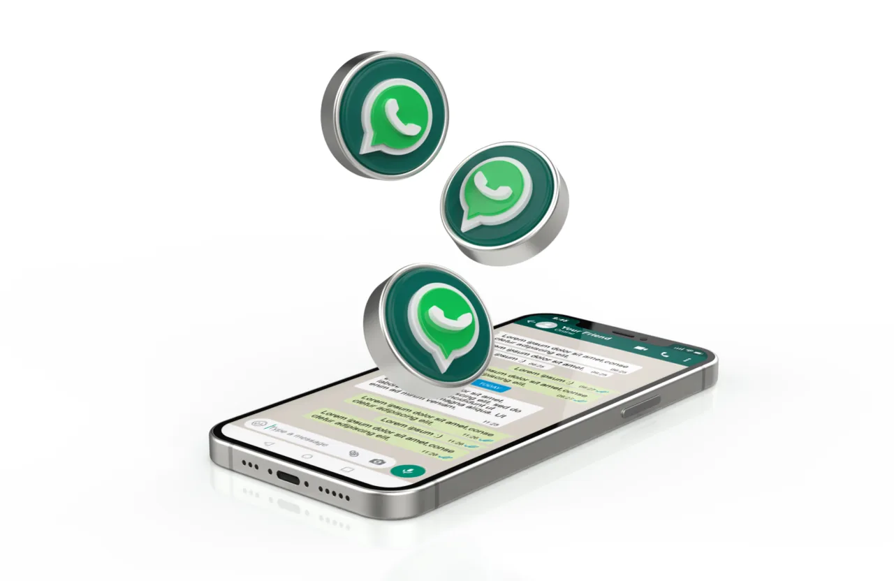 A phone showing a WhatsApp conversation, with WhatsApp icons floating above it